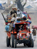 A Pakistan Earthquake Survivor Family Ride a Vehicle as They Make Their Way to Mansehra