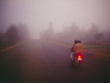 A Couple on a Motorcycle Head into Town Early in the Morning