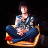 Marc Bolan Leader of Pop Group T Rex Sitting Cross Legged in Chair