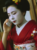 A Kimono-Clad Geisha Talks on a Cell Phone