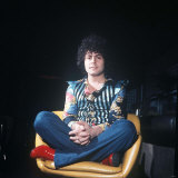 Marc Bolan Leader of Pop Group T Rex Sitting Cross Legged in Chair