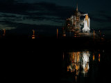 The Space Shuttle Atlantis is Reflected in a Pond on Pad 39B