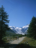 A Couple Walks Toward the Morteratsch Glacier in Switzerland