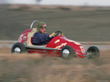 A Young Girl Reacts as She Drives Her "Midget Racer" off the Track