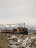 A Train Follows Alongside a River