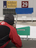 A Man Shoots at a Target in the Distance During a Biathalon