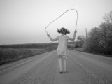 A Girl Jumps Rope Down a Gravel Road in Nebraska