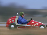 A Young Boy Races a "Midget Racer" Around a Track
