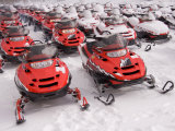 A Row of Snowmobiles Sit Waiting for the Next Adventure to Start