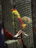 A Hand Reaches out to Touch a Name on the Vietnam Wall