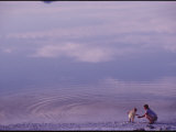 A Mother and Child Playing by a Lake