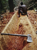 A Man Carving a Dugout Canoe from a Log