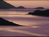 Vibrant Sunset Silhouettes the Glacial Mountains on Either Side of the Water