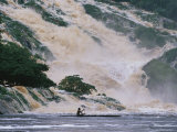 A Man on a Canoe Near the Crashing Waters of Kongou Falls