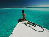 A Woman Sits on the Front of a Boat and Enjoys the Ocean Scenery