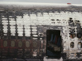 The Burnt out Hull of a Jet Sits on a Tarmac
