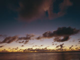 Inky Puffs of Cloud over a Broad Rain Forest River at Twilight
