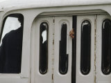 Fingers Hang out of a Crowded Bus Door