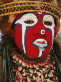 A Tribal Woman Clad with Shell Necklaces and Bright Face Paint