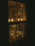 View of Candles and a Christmas Tree Through a Window