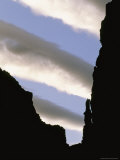 Stripes of Clouds Can Be Seen from Inside a Silhouetted Canyon