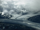 Branches of a Glacier Join Together Below Cloud-Covered Peaks