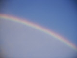 A Rainbow Arcs Across the Sky Above Salt Lake City  Utah