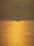 Sunlight on the Hooghly River and Mist Enshrouded Riverside Buildings