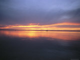 A Sunset with Sailboats in the Distance
