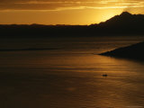A View of Lake Titicaca at Sunset with a Small Boat