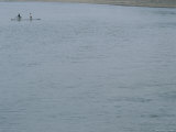 A Bicyclist is Ferried Across the Li River on a Narrow Raft