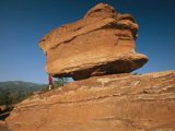 A Young Boy Climbs on a Sandstone Rock Formation