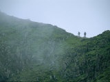 Hikers Climb a Fog-Shrouded Ridge on Mount Snowdon