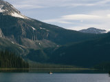 Boaters Enjoying Emerald Lake in the Shadow of Mountains