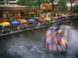 The Blur of a Passing Tourist Boat Along the Colorful Riverwalk