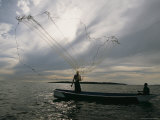 A Ugandan Man Casts a Fishing Net for Tilapia