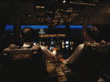 Pilots Sitting in the Cockpit at Night