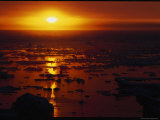 The Setting Sun Reflected on Water Dotted with Chunks of Ice
