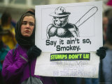 A Logging Protester Holds a Sign at a Demonstration