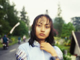 Soaked by the Rain  a Bewildered Girl Stares at the Photographer