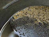 Close View of Gold Nuggets Scattered in a Gold Pan