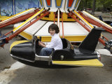 A 6-year-old Girl Rides a Vintage Carnival Ride