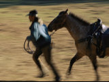 A Cowboy Leads a Horse at Coffee Creek Ranch