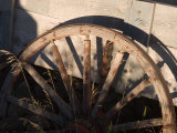 An Old Wagon Wheel Sits Rotting in the Afternoon Sun