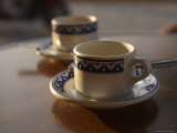 Two Coffee Cups Sit on a Table