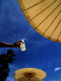Tourist Holding a Cool Drink at the Amanpuri Hotel in Phuket