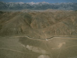 An Aerial View of a Mountain Valley Bisected by a Road