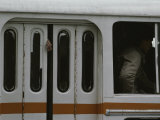A Mans Hand Hangs out of a Closed Door on a Crowded Bus
