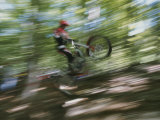 A Boy Flies Through the Air on His Mountain Bike
