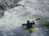 A Kayaker Paddles Through White-Water Rapids on the Snake River